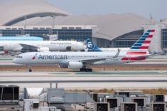 an american airlines plane on the tarmac at an airport in front of other planes