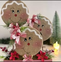 three gingerbread man and woman ornaments with poinsettis