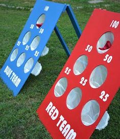 two cornhole game boards sitting in the grass