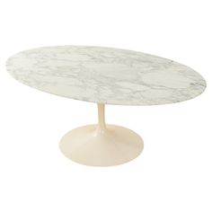 an oval marble table with a white base on a white background for use as a centerpiece