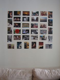 a white couch sitting in front of a wall with pictures hanging on it's side