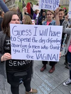 a group of people holding signs and protesting