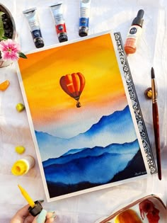 an artist's painting with watercolors and paintbrushes