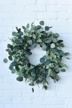 a white brick wall with a wreath hanging on it