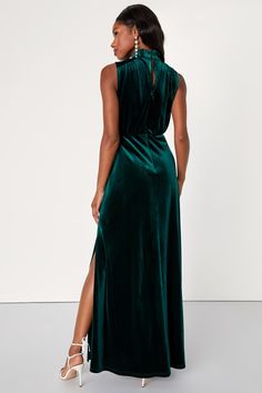 Feel like the Queen that you are in the Lulus Classic Elegance Emerald Velvet Sleeveless Mock Neck Maxi Dress! Plush velvet shapes this gorgeous dress that has a mock neckline and a sleeveless bodice with gathered fabric detailing. An elasticized waist tops a stunning maxi skirt complete with twin side slits. Cute keyhole cutout secures with a double button closure at back. Hidden back zipper/clasp. Fit: This garment fits true to size. Length: Floor length. Size medium measures 60.5" from should Green Wedding Guest Dresses, Mock Neck Maxi Dress, Fabric Detailing, Emerald Velvet, Gathered Fabric, Velvet Dress Casual, Sleeveless Mock Neck, Green Velvet Dress, Dress Drape