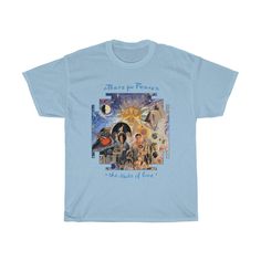 a light blue t - shirt with an image of people in the sky and stars