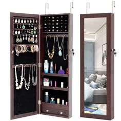 an open wooden jewelry cabinet with mirrors on the sides and shelves filled with necklaces