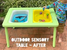 a little boy playing with his outdoor table