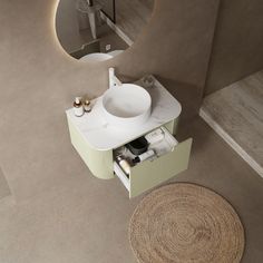 a white sink sitting under a mirror next to a rug on the floor in a bathroom