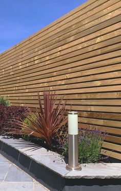 a wooden fence is next to some plants