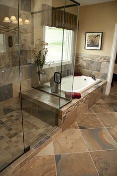 a bath tub sitting inside of a bathroom next to a window