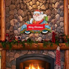 a fireplace with a santa clause sign above it