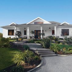 a white house with steps leading up to the front door