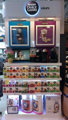 there is a display in the store with coffee cups on it and other items for sale