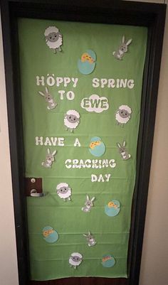 a green door decorated with sheep and words that say, happy spring to ewe have a cracking day