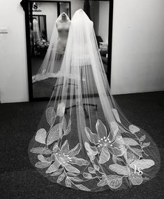 the veil is hanging in front of a wedding dress