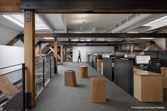 an open office with lots of cubicles and desks on each side of the room