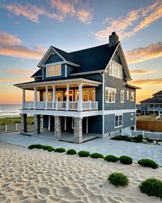 a house on the beach at sunset