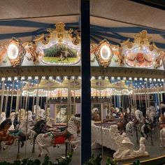 an image of a merry go round with horses and carousels in the foreground