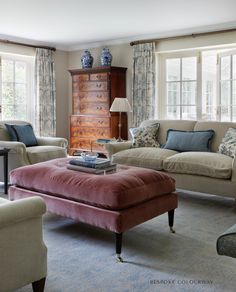 a living room filled with furniture and windows