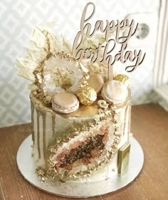 a birthday cake is decorated with shells and frosting