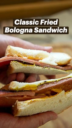 a person holding a sandwich in their hand with the words classic fried bologna sandwich on it