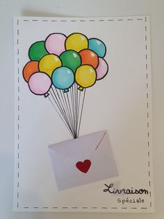 an envelope with balloons in it and a red heart attached to the front, on a white background