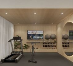 an exercise room with treadmills and television in the backround, surrounded by mirrors