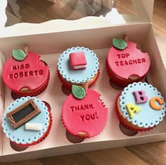 a box filled with cupcakes decorated like apple's and thank you written on them