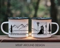 two white coffee mugs with the words wrap around design on them sitting on a wooden table