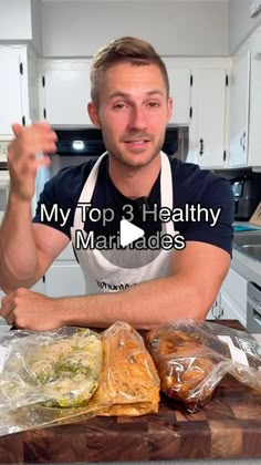 a man in an apron standing next to some food on a cutting board with the words, my top 3 healthy meals