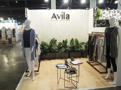 a store display with clothing and plants in it