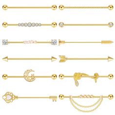 a collection of gold and silver colored metal barbell rings with different designs on them