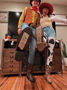 two people in cowboy hats sitting on top of each other