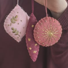 three ornaments are hanging from the string