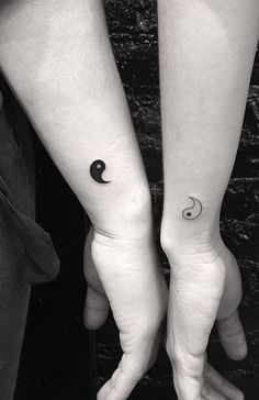 two people with matching tattoos on their arms