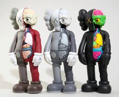 three toy figures are standing next to each other in front of a white background,