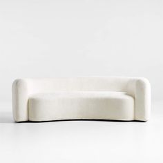 a white couch sitting on top of a white floor