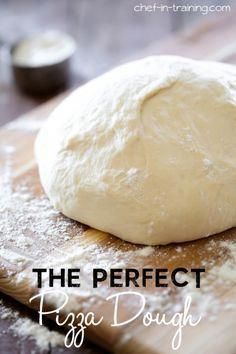 a ball of dough sitting on top of a wooden cutting board