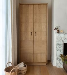 a wooden cabinet sitting next to a fireplace in a living room