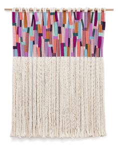 the wall hanging is decorated with multicolored sticks