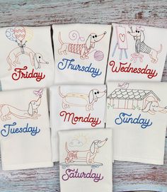 four embroidered tea towels with dogs on them and the words friday, wednesday, saturday