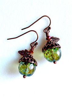 Beautiful translucent 12 mm translucent luminous green faceted Czech glass beads with rustic Picasso finish topped with artisan antique copper acorn bead caps. Earrings are wire wrapped in copper and accented with darling little antique copper TierraCast two sided oak leaf charms, antique copper daisies and tiny iridescent burnt orange Czech crystals. They hang from antique copper French hooks. Length is 1 1/2". Handmade Copper Green Earrings, Orange Czech Glass Jewelry With Ear Wire, Nature-inspired Copper Earrings As Gift, Unique Green Czech Glass Earrings, Nature-inspired Copper Dangle Earrings, Fall Cottagecore, Cottagecore Jewelry, Woodland Earrings, Fall Earrings