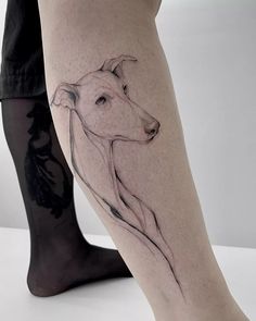 a woman's leg with a dog tattoo on it and her legs are shown