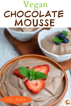 chocolate mousse in a bowl with strawberries and mint leaves on the side