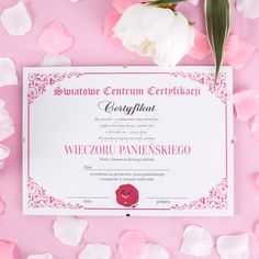 an award certificate with pink flowers and petals on a pink background in front of it