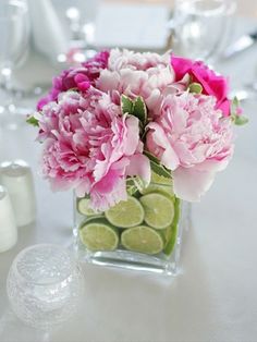 a vase filled with pink flowers on top of a table