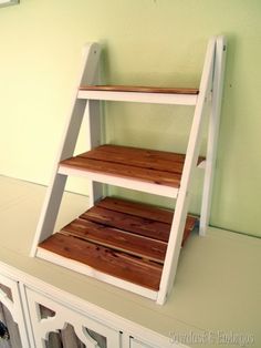 a ladder shelf sitting on top of a white dresser