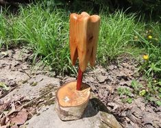 a tree stump with a toothpick sticking out of it's side on top of a rock