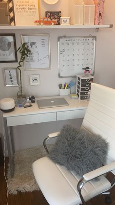 a white chair sitting in front of a desk